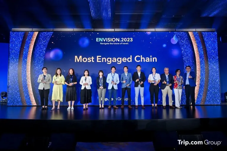 Dorsett staff members holding awards on a stage.