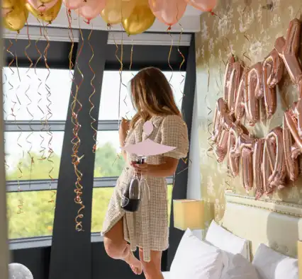 Birthday celebration for a girl in a bedroom.