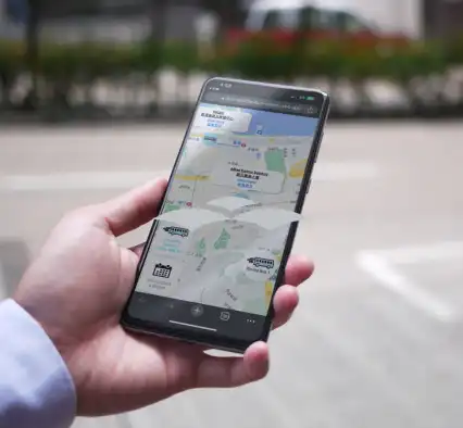 A person holding smartphone with a view of a map.