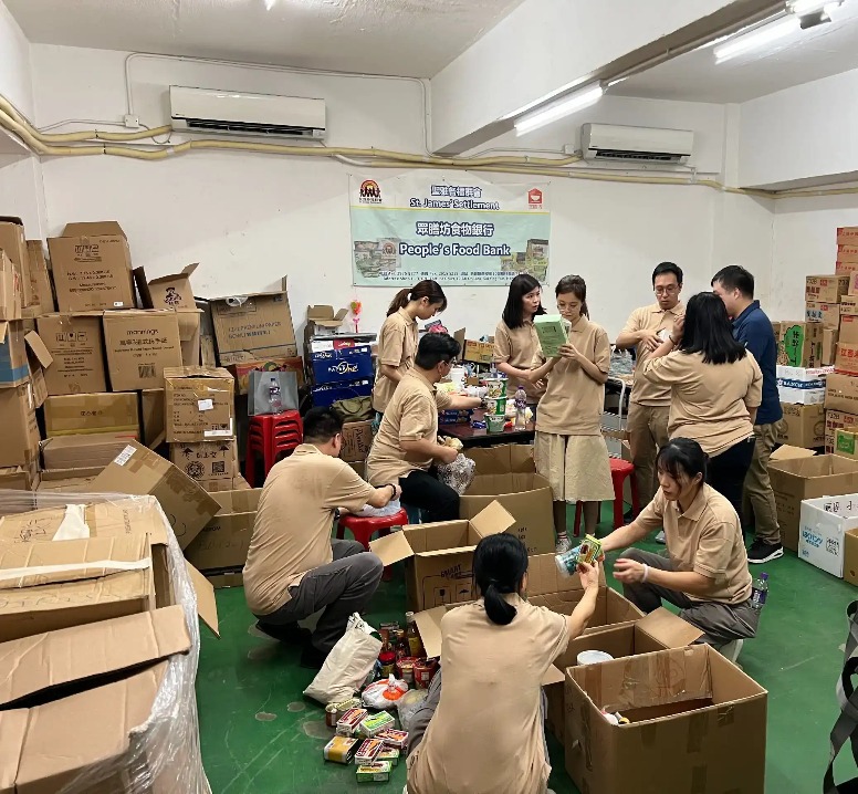 People preparing boxes with essential goods.