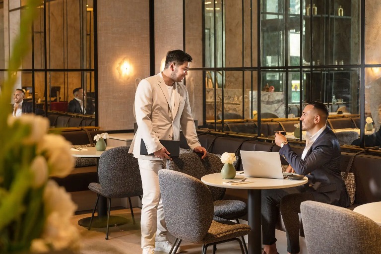 Club lounge with staff serving guests at Dorsett Hotels