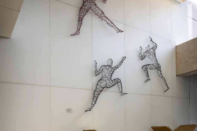 Two wire sculptures of human figures at Dorsett Changi City Singapore.