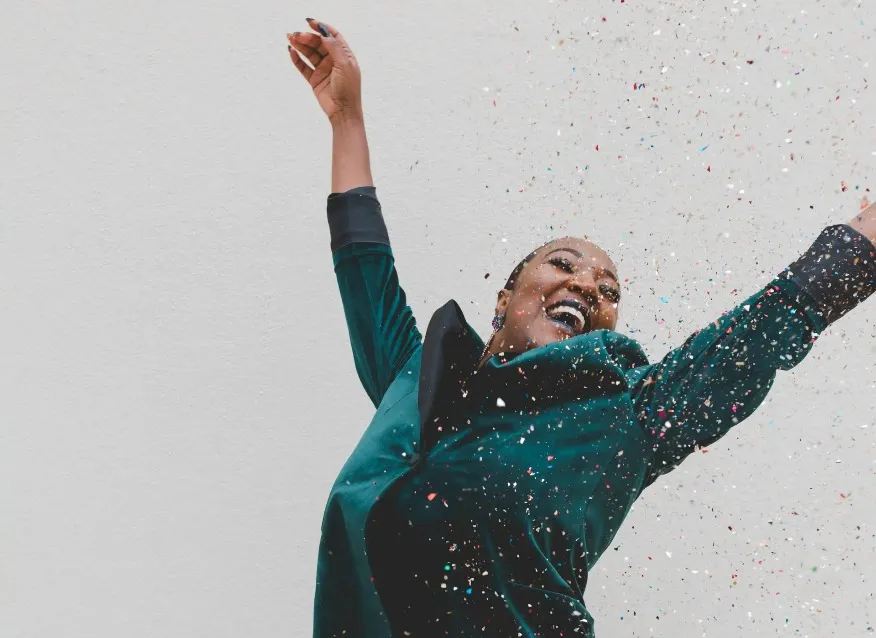 Woman throwing confetti in the air.