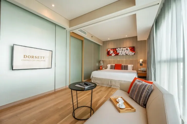 Bed, settee and TV in the Splash Room at Dorsett Changi.