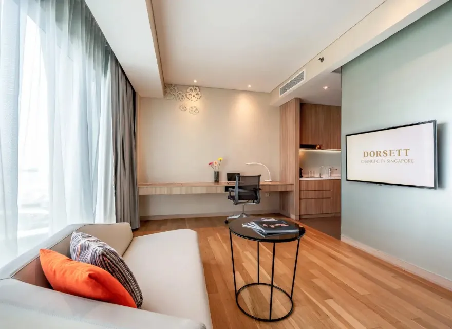 Bed, settee and TV in the Splash Room at Dorsett Changi.