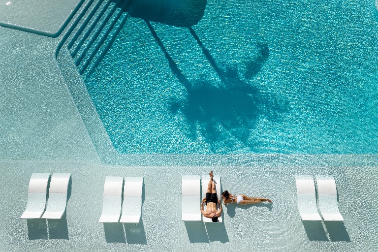 A couple enjoying outdoor pool at Dorsett Gold Coast