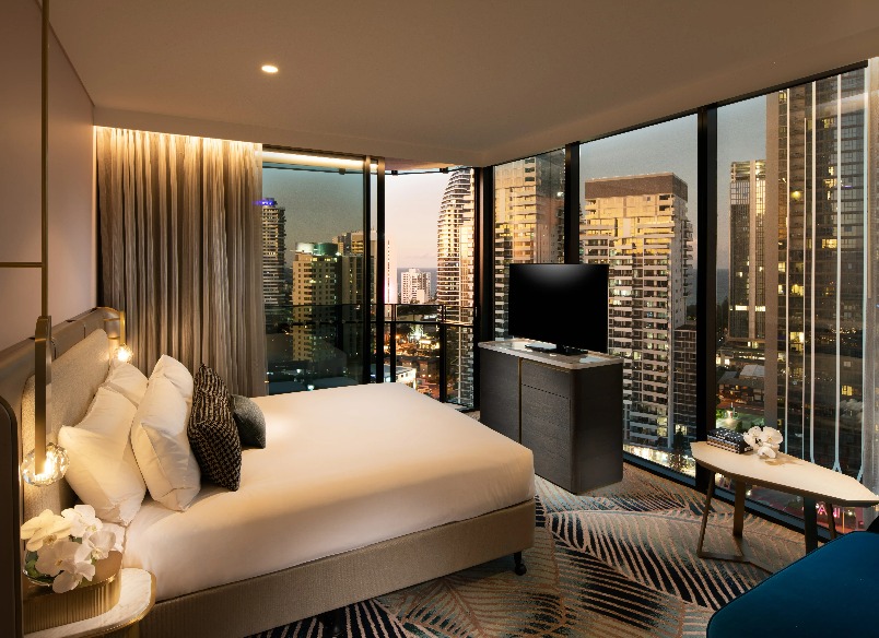 A TV by a bed at Dorsett Gold Coast Deluxe King Panoramic Room