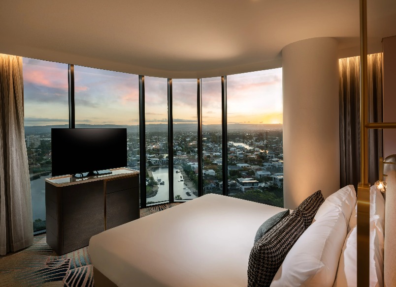 A TV by a bed at Dorsett Gold Coast Executive King Corner Room