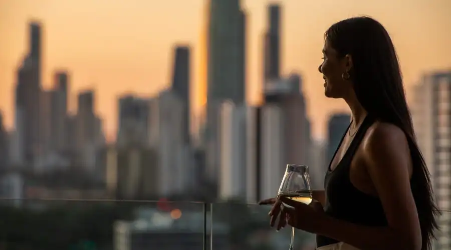 A woman admiring the view from Dorsett Gold Coast at sunset