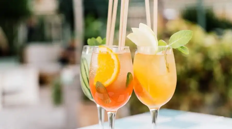 Three tropical cocktails served at a rooftop bar