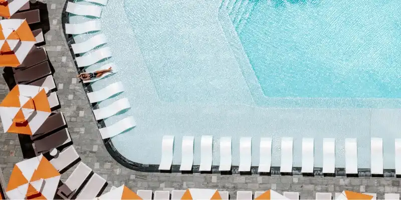 Woman on wet lounge in pool Woman on wet lounge in pool