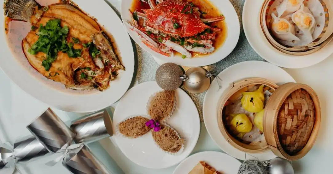 Flat lay of Christmas themed Chinese dishes styled with bon-bons