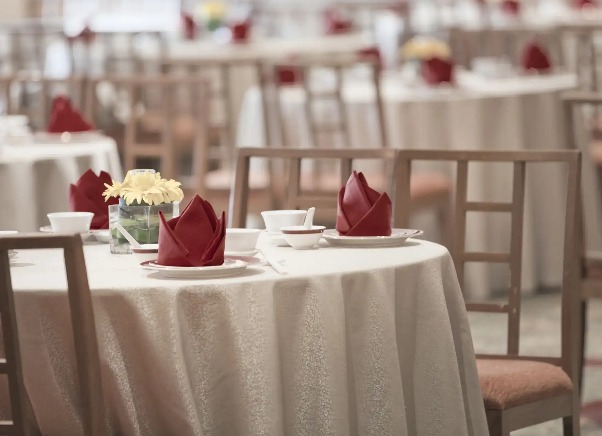 Elegant round tables with white tablecloths at The Emperor restaurant