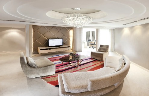 Settee, TV and chandelier in Executive Suite at Dorsett Grand Subang.