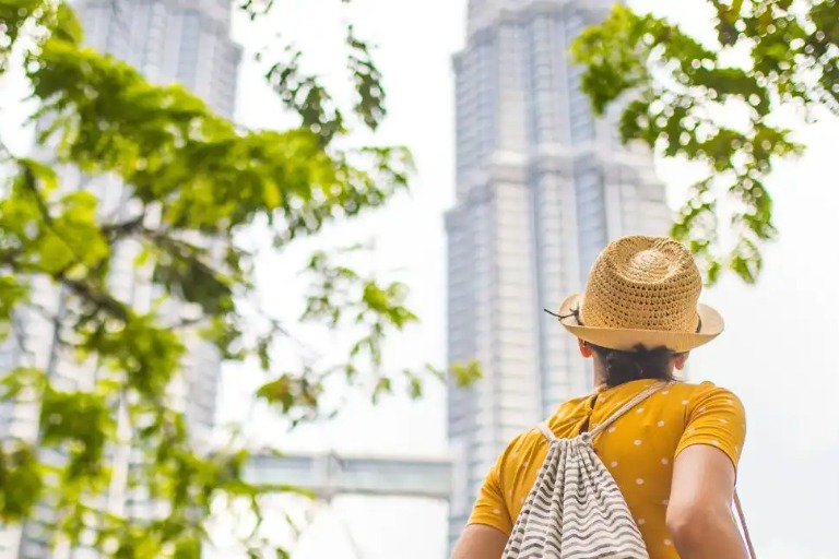 Lady looking at the Twin Towers in Kuala Lumpur Singapore. 