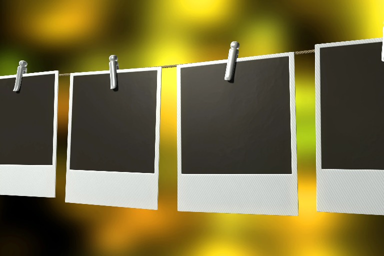 Empty photo frames on a clothesline.