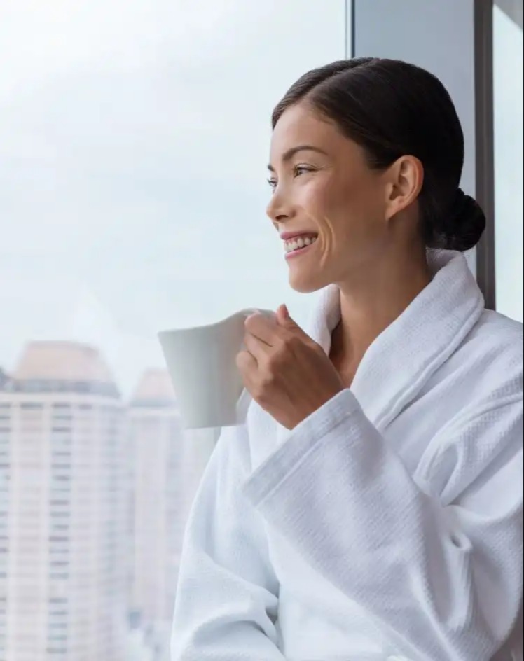 Woman wearing a bathrobe in Dorsett Hartamas Kuala Lumpur room.