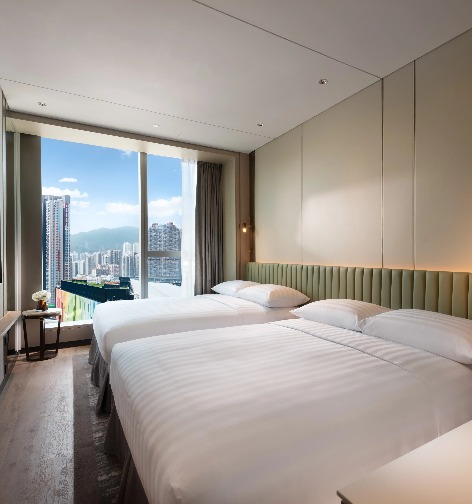 King-size bed overlooking the Kai Tak Sports Park.