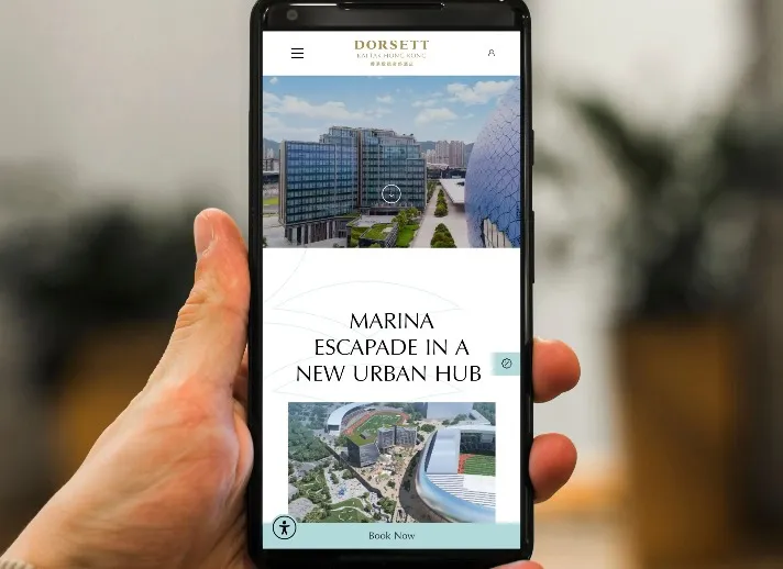 Person views the Dorsett kai Tak hotel website using a phone