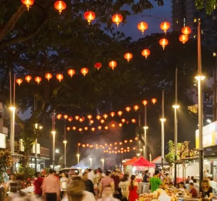 A street with colourful lights and street food.