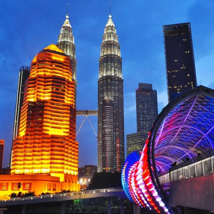 Petronas Twin Towers and a futuristic-looking bridge in the foreground.