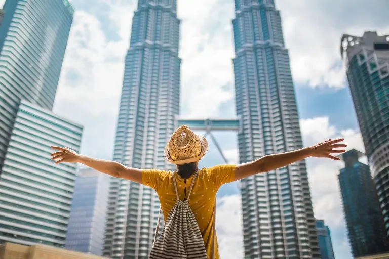 Person looking the Petronas Twin Towers.