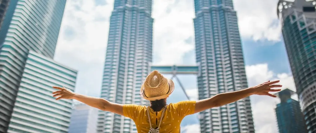 Person looking the Petronas Twin Towers.