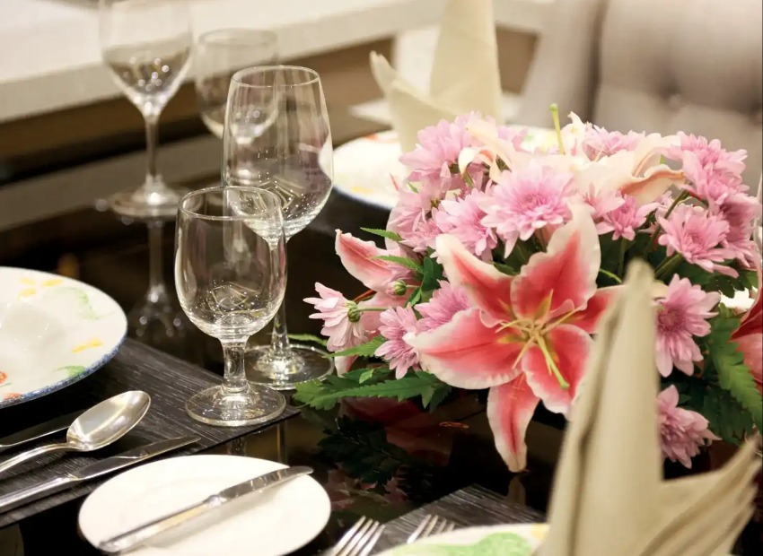 Artificial flowers and glasses on tables at Dorsett Kuala Lumpur. 