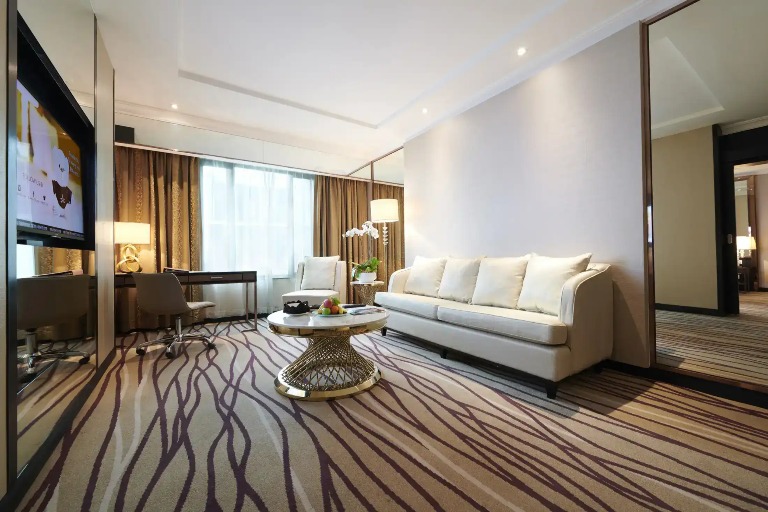 Settee, couch and TV in Dorsett Kuala Lumpur Hotel room.