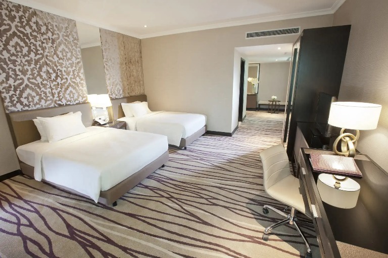 Two single beds in the Dorsett Kuala Lumpur Deluxe Premier Bedroom.