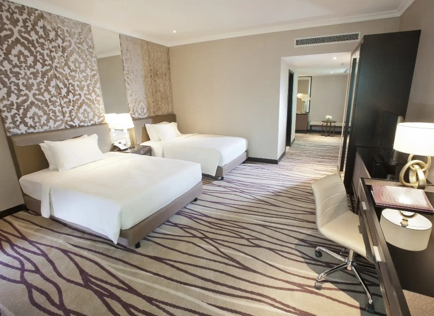 Two single beds in the Dorsett Kuala Lumpur Deluxe Premier Bedroom.