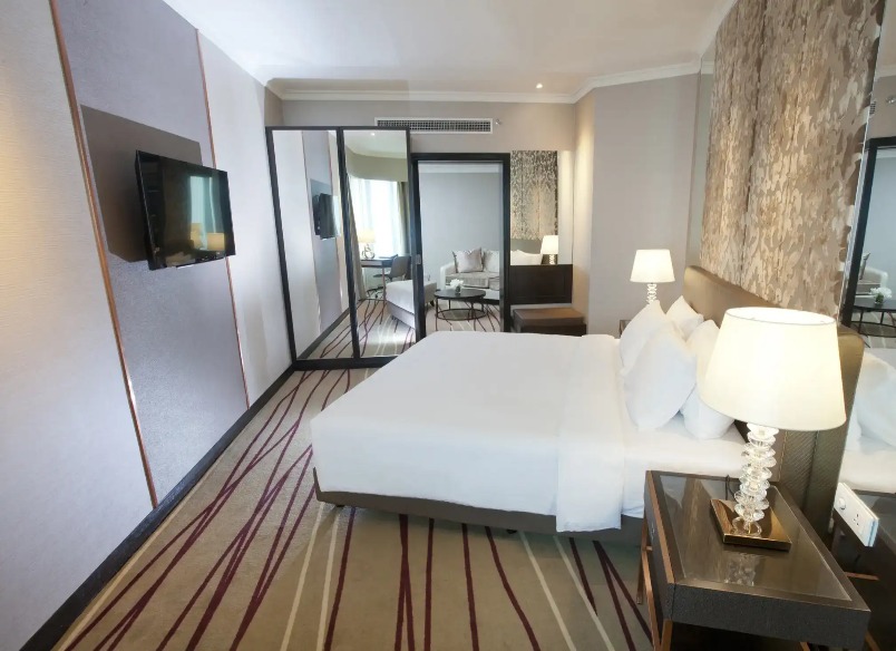 TV, bedroom and mirror in the Dorsett Suite at Dorsett Kuala Lumpur.