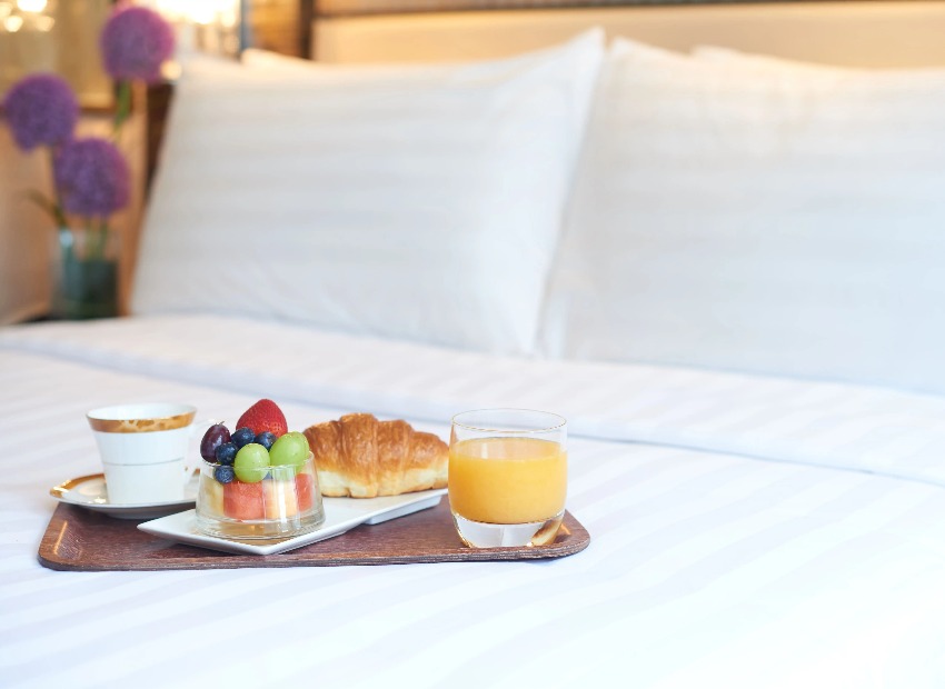 Food and beverages in a bedroom at Dorsett Kwun Tong Hotel.