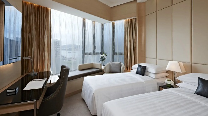 Beds, sofa and work desk in the Dorsett Kwun Tong Standard Room.