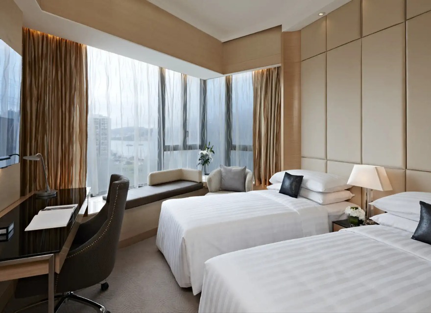 Beds, sofa and work desk in the Dorsett Kwun Tong Standard Room.