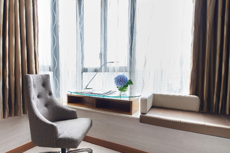 Sofa by the work desk in the Dorsett Kwun Tong Standard Room.