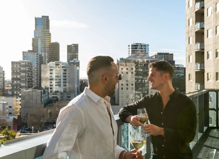 Men enjoying view from Dorsett Melbourne Balcony Suite