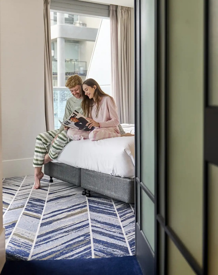 Couple reading a magazine by the window, Dorsett Melbourne