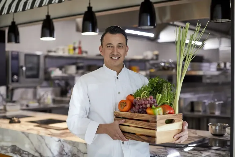 Chef holding vegetables at Dorsett Melbourne Hotel