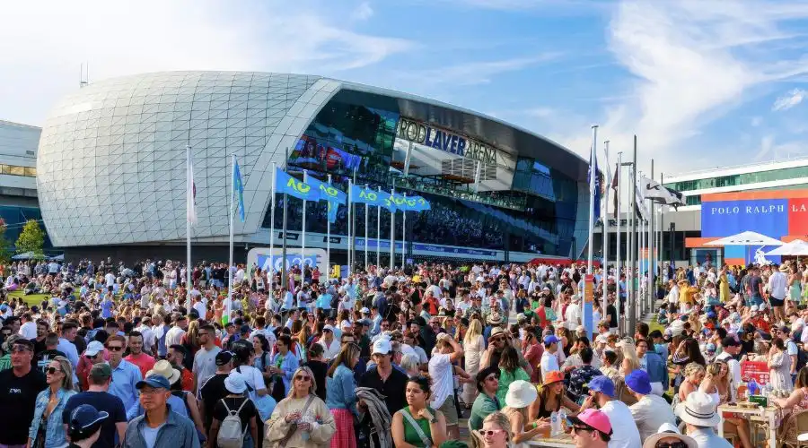 Crowds gather outside the Australian Open tennis courts on a sunny day