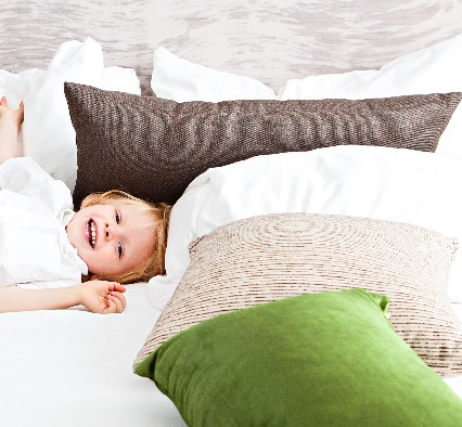 A kid is resting on a bed at Dorsett Mongkok