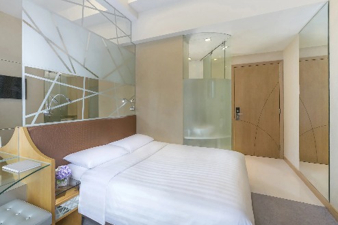 Queen-size bed and amenities in Dorsett Mongkok Superior Room