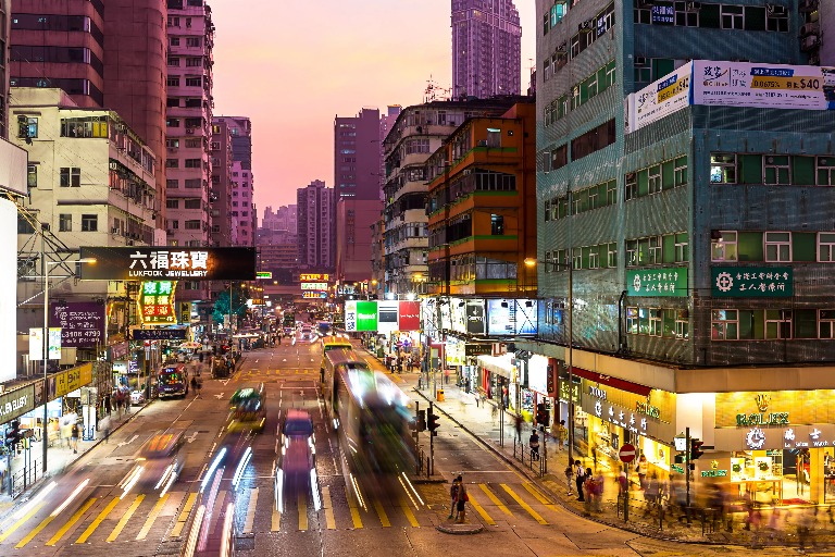 City market in Mongkok with neon lights and busy streets at night