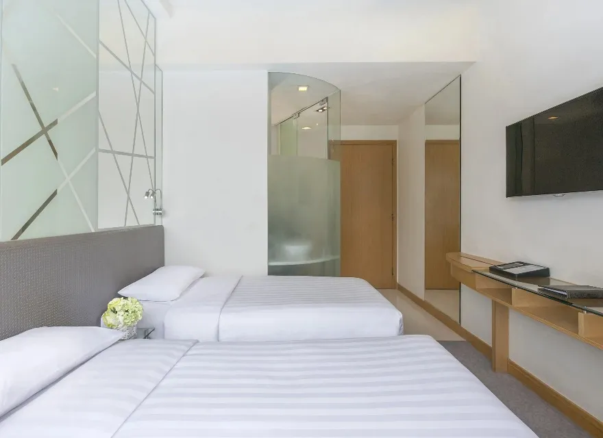 Two twin beds and other amenities in Room Comfort at Dorsett Mongkok