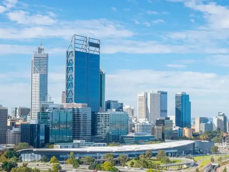 The vibrant cityscape of Perth Australia with massive skyscrapers, is captured from a long-angle perspective.