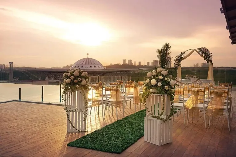 Outdoor wedding on the Dorsett Putrajaya rooftop overlooking a mosque.