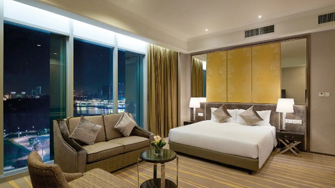 King bed and settee in a Dorsett Putrajaya Hotel room.