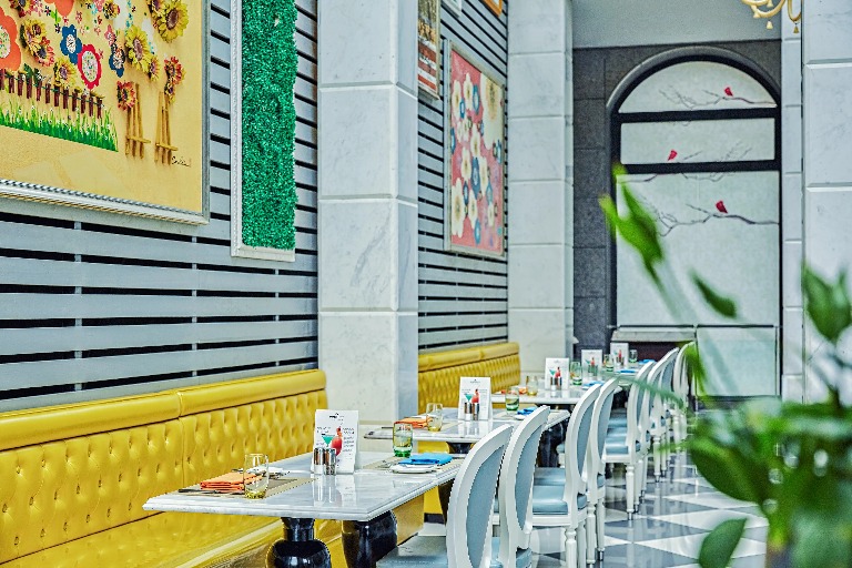 Yellow booths and white chairs at the Xin Guang Chinese Restaurant