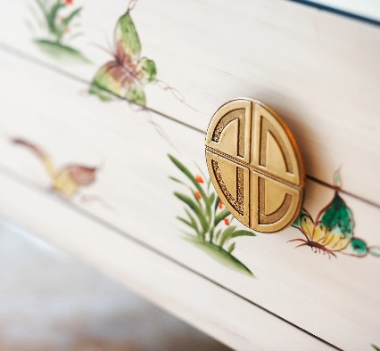 Close-up of a drawer with a decorative knob.