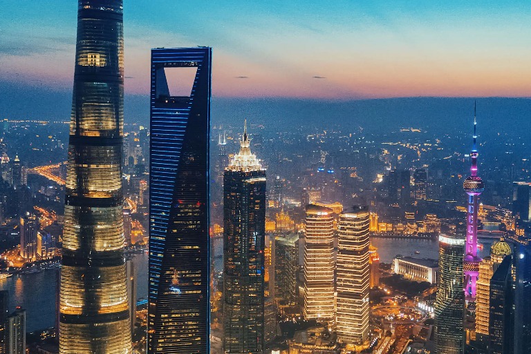 Buildings with warm lighting on the exterior at night.